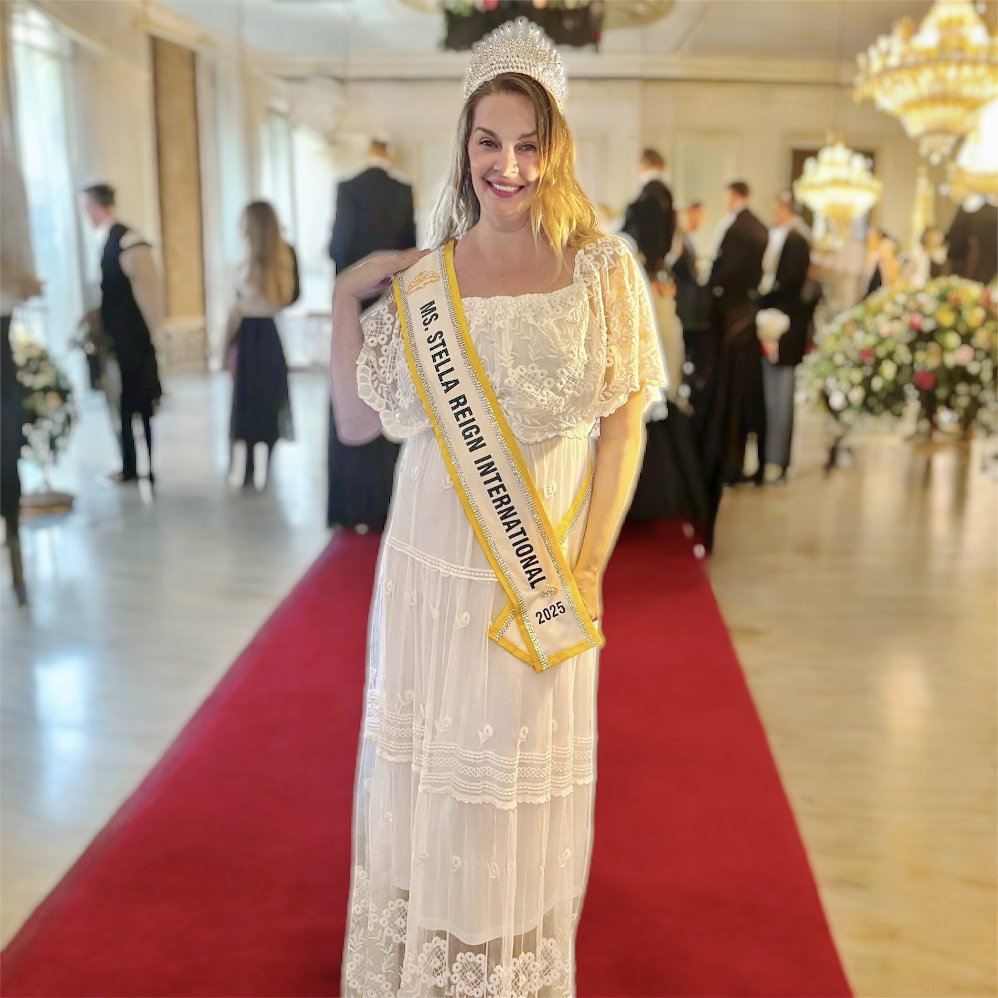 Kimberly Lewis, Ms. Stella Reign International 2025, full-length on the red carpet in her crown and sash