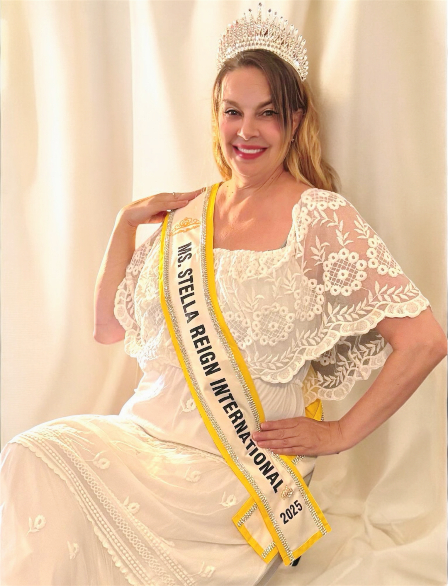 Kimberly Lewis, Ms. Stella Reign International 2025, seated in her crown and sash